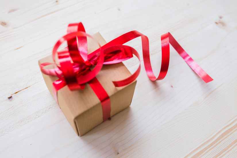 red ribbon on brown cardboard box